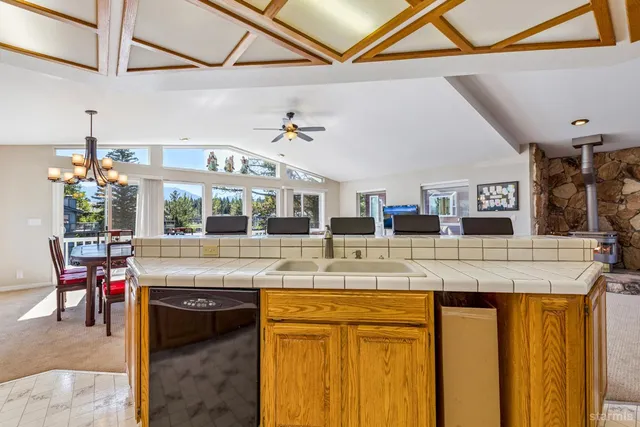 a kitchen with cabinets and chairs