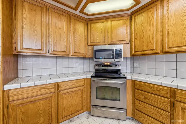 a kitchen with a stove a sink and a microwave