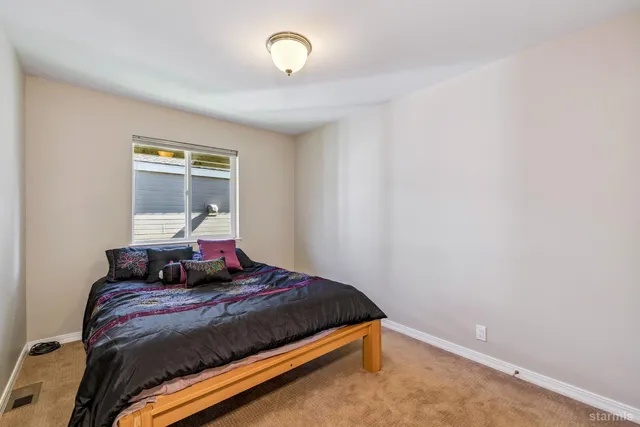 a bedroom with a bed and window