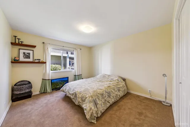 a bedroom with a bed and dresser