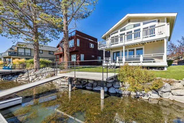 a swimming pool view with a seating space and a garden view