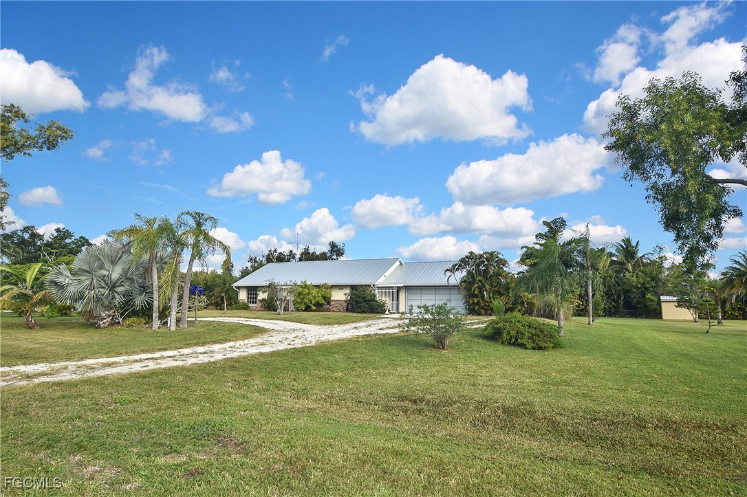 4658 Gulf Shore Road St. James City, FL 33956 - Photo 11 of 50 a view of a big yard with palm trees