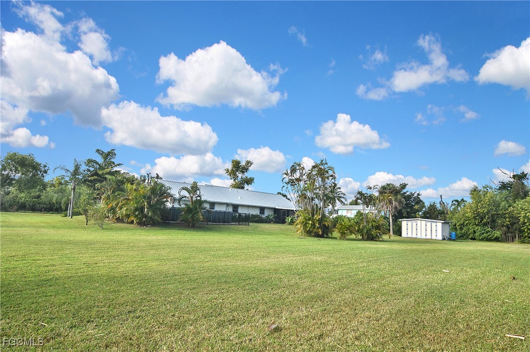 4658 Gulf Shore Road St. James City, FL 33956 - Photo 12 of 50 a view of a fountain in front of a house with a big yard