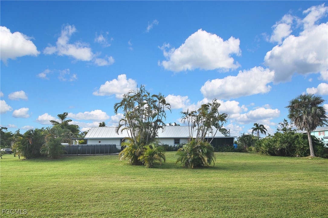 4658 Gulf Shore Road St. James City, FL 33956 - Photo 13 of 50 a view of a fountain in middle of the green field