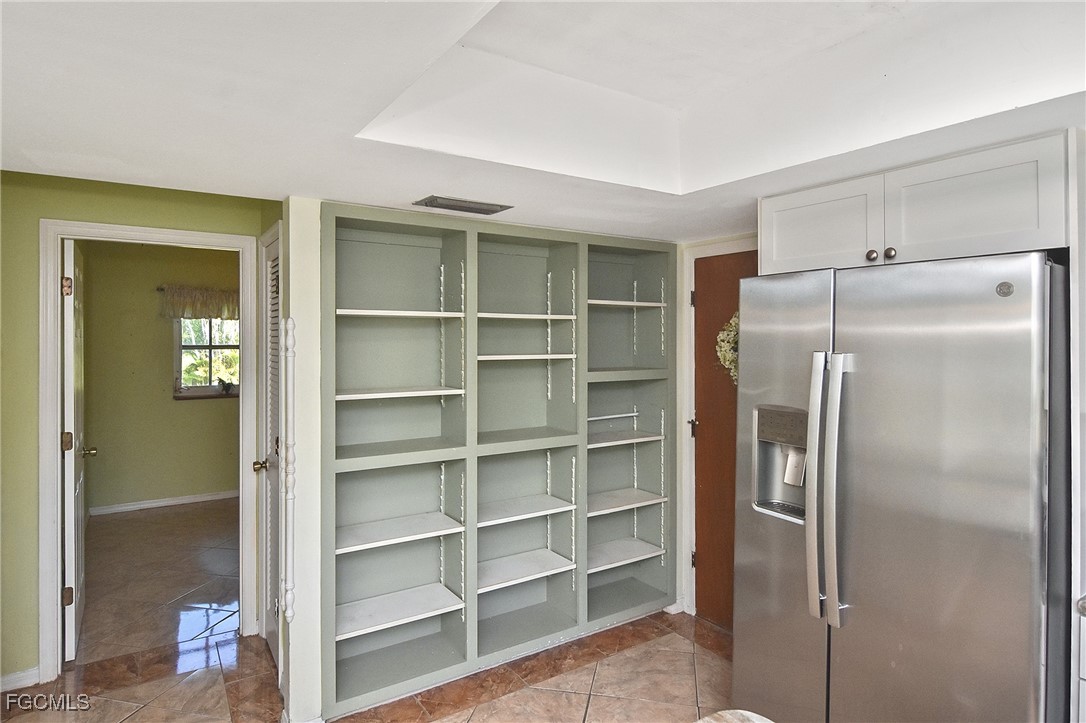 4658 Gulf Shore Road St. James City, FL 33956 - Photo 17 of 50 a kitchen with a refrigerator and cabinets