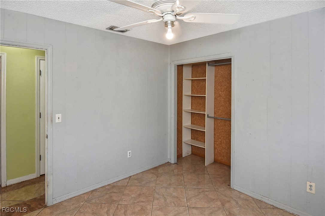 4658 Gulf Shore Road St. James City, FL 33956 - Photo 30 of 50 an empty room with closet and fan