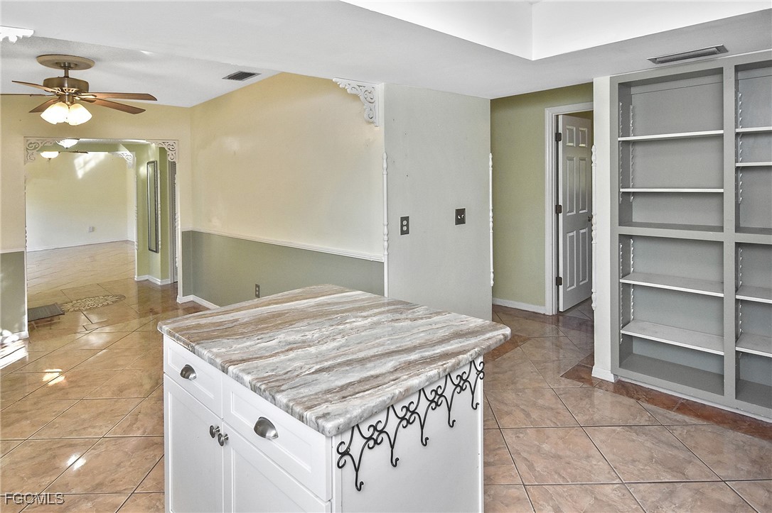 4658 Gulf Shore Road St. James City, FL 33956 - Photo 36 of 50 a spacious bathroom with a granite countertop sink and a mirror