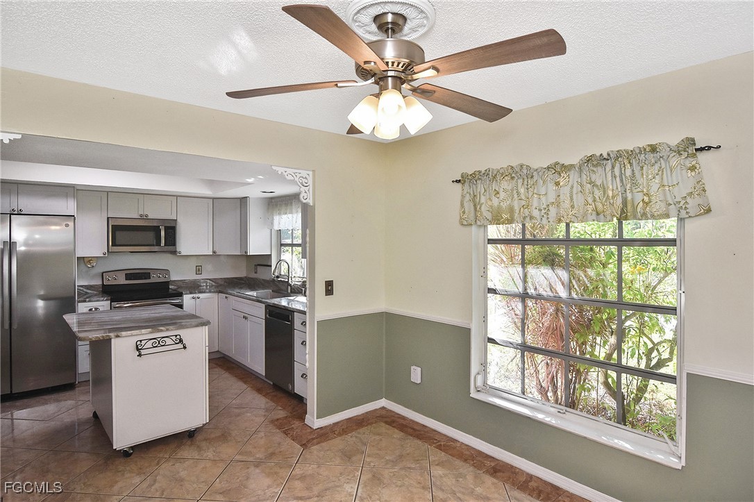 4658 Gulf Shore Road St. James City, FL 33956 - Photo 37 of 50 a kitchen with stainless steel appliances granite countertop a stove and a sink
