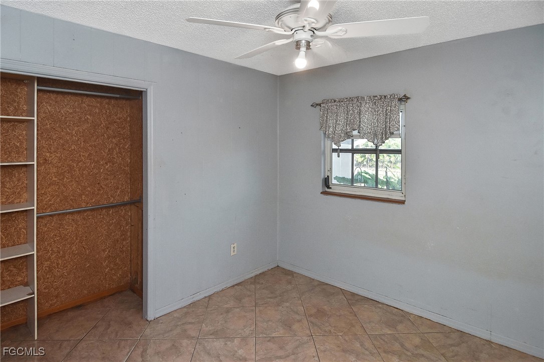 4658 Gulf Shore Road St. James City, FL 33956 - Photo 39 of 50 an empty room with windows and fan
