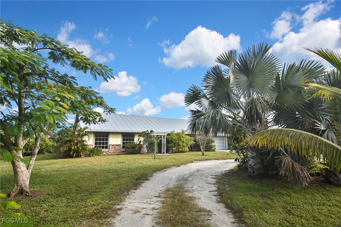 4658 Gulf Shore Road St. James City, FL 33956 - Photo 4 of 50 a front view of a house with garden