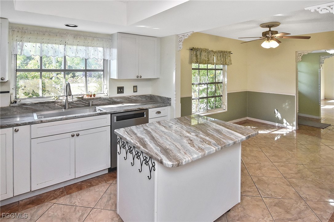 4658 Gulf Shore Road St. James City, FL 33956 - Photo 43 of 50 a kitchen with a sink stove and cabinets