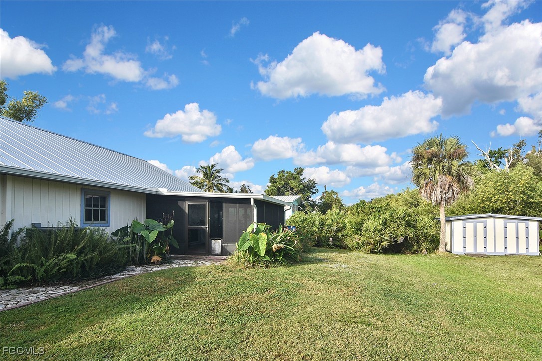 4658 Gulf Shore Road St. James City, FL 33956 - Photo 6 of 50 a view of a house with backyard and garden