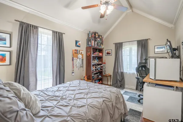 a bedroom with a bed and a window