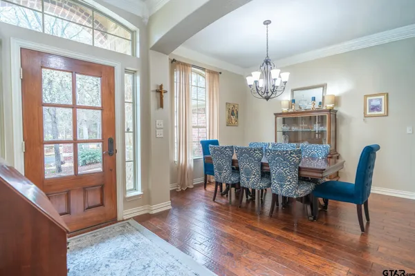 a bedroom with a large bed and a chandelier