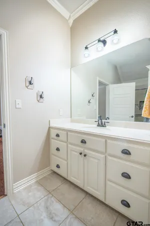 a bathroom with a granite countertop toilet sink and mirror