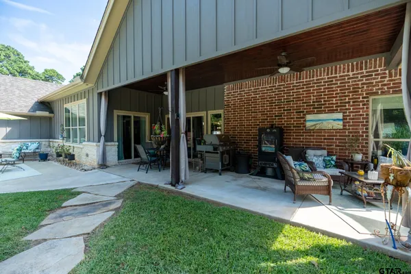 a view of backyard with swimming pool and table under an umbrella