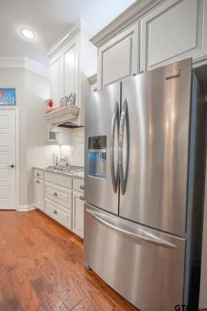 a kitchen with stainless steel appliances white cabinets and a sink