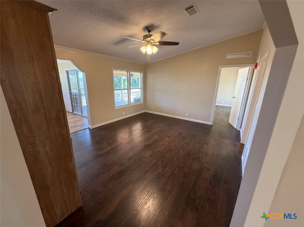 4551 Chamberlain Way Canyon Lake, TX 78133 - Photo 12 of 34 a view of an empty room with wooden floor and a window
