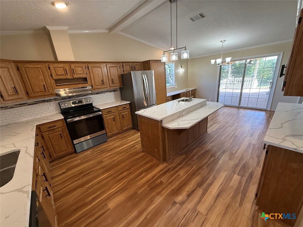 4551 Chamberlain Way Canyon Lake, TX 78133 - Photo 18 of 34 a kitchen with wooden floors and refrigerator