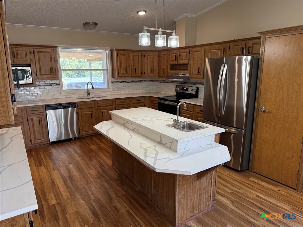 4551 Chamberlain Way Canyon Lake, TX 78133 - Photo 2 of 34 a kitchen with a sink a counter space and stainless steel appliances