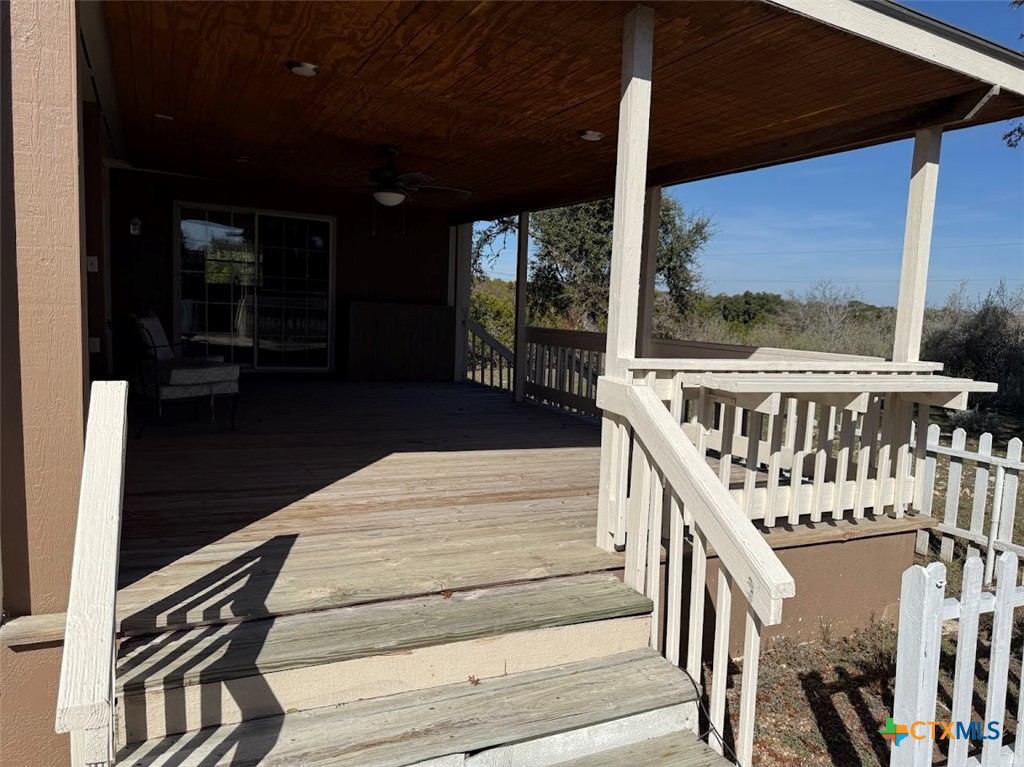 4551 Chamberlain Way Canyon Lake, TX 78133 - Photo 28 of 34 a view of a balcony with wooden floor and furniture