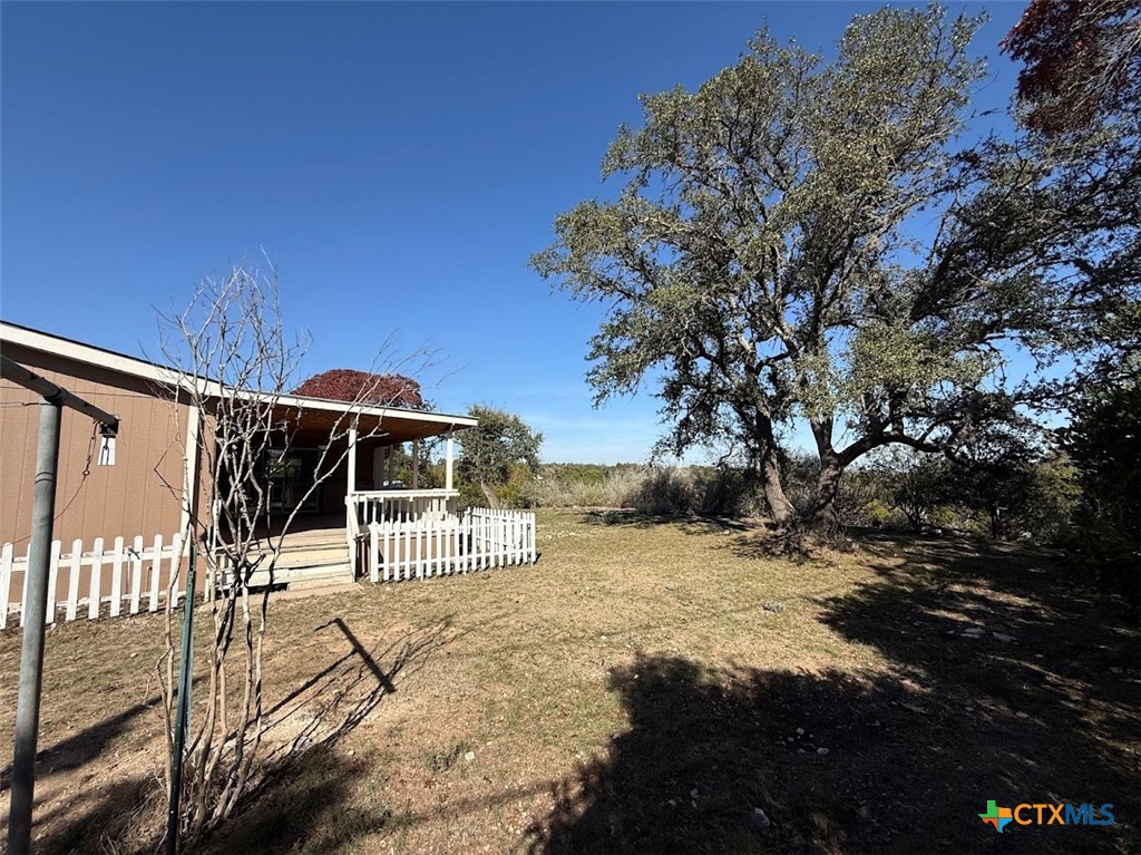 4551 Chamberlain Way Canyon Lake, TX 78133 - Photo 29 of 34 a view of a house with backyard and sitting area