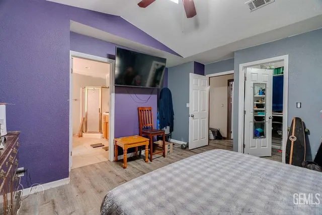 a living room with furniture a flat screen tv and a large window