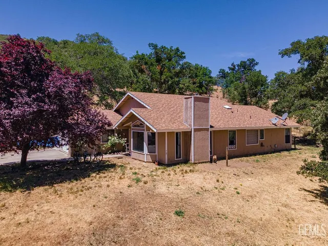 a view of a house with a yard covered in snow