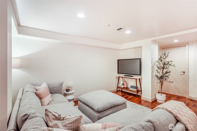 a living room with furniture and a lamp