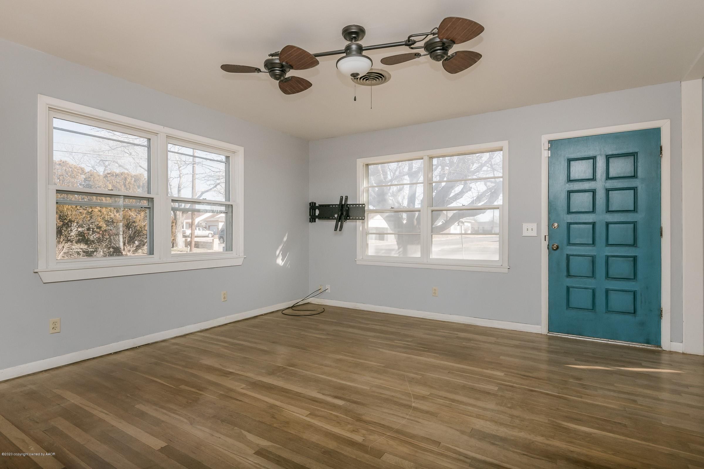4200 South Bonham Street Amarillo, TX 79110 - Photo 3 of 20 a view of an empty room with a window and wooden floor
