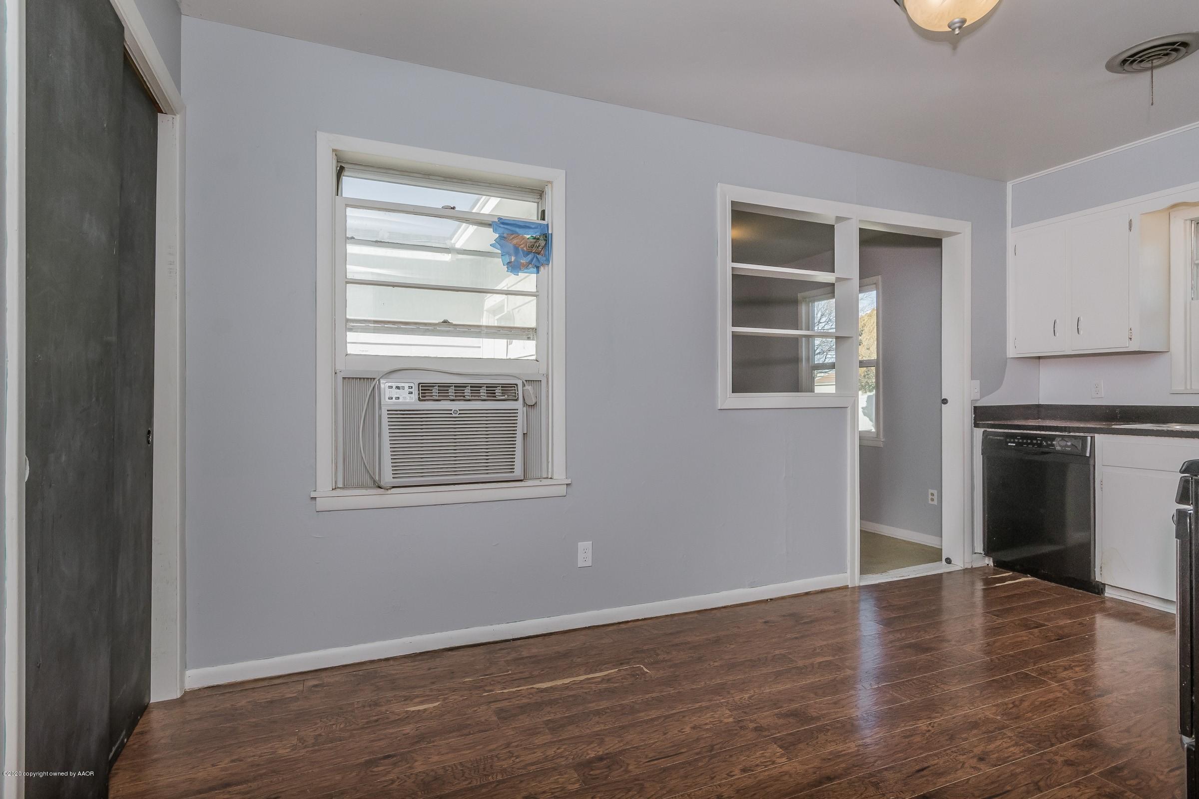 4200 South Bonham Street Amarillo, TX 79110 - Photo 5 of 20 a view of an empty room with a window and wooden floor
