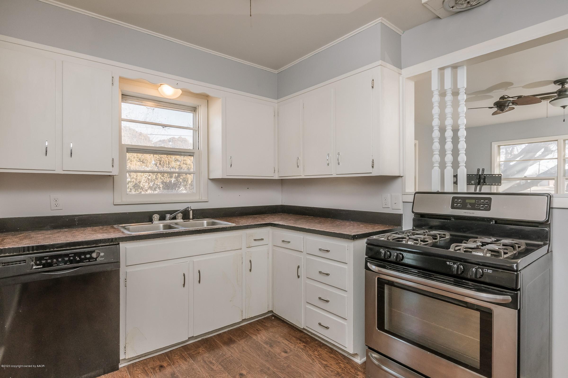 4200 South Bonham Street Amarillo, TX 79110 - Photo 6 of 20 a kitchen with granite countertop white cabinets and stainless steel appliances