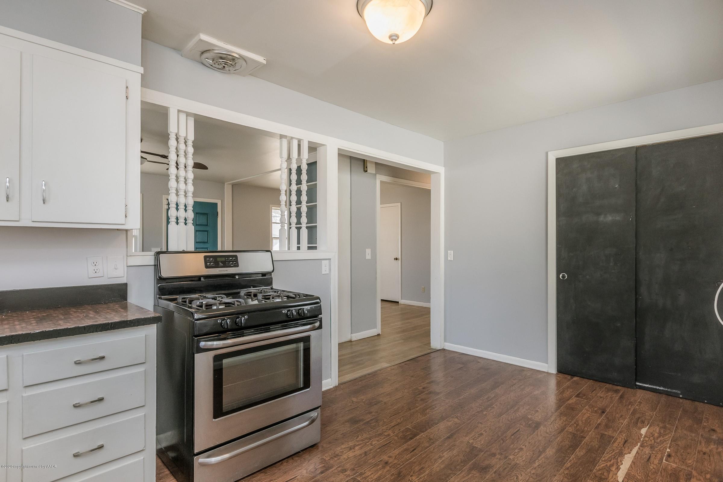 4200 South Bonham Street Amarillo, TX 79110 - Photo 8 of 20 a kitchen with granite countertop a stove and a refrigerator