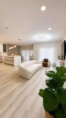 a bedroom with a large bed and a view of living room