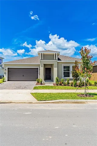a front view of a house with a big yard