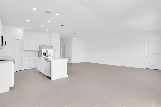 a view of kitchen with white cabinets