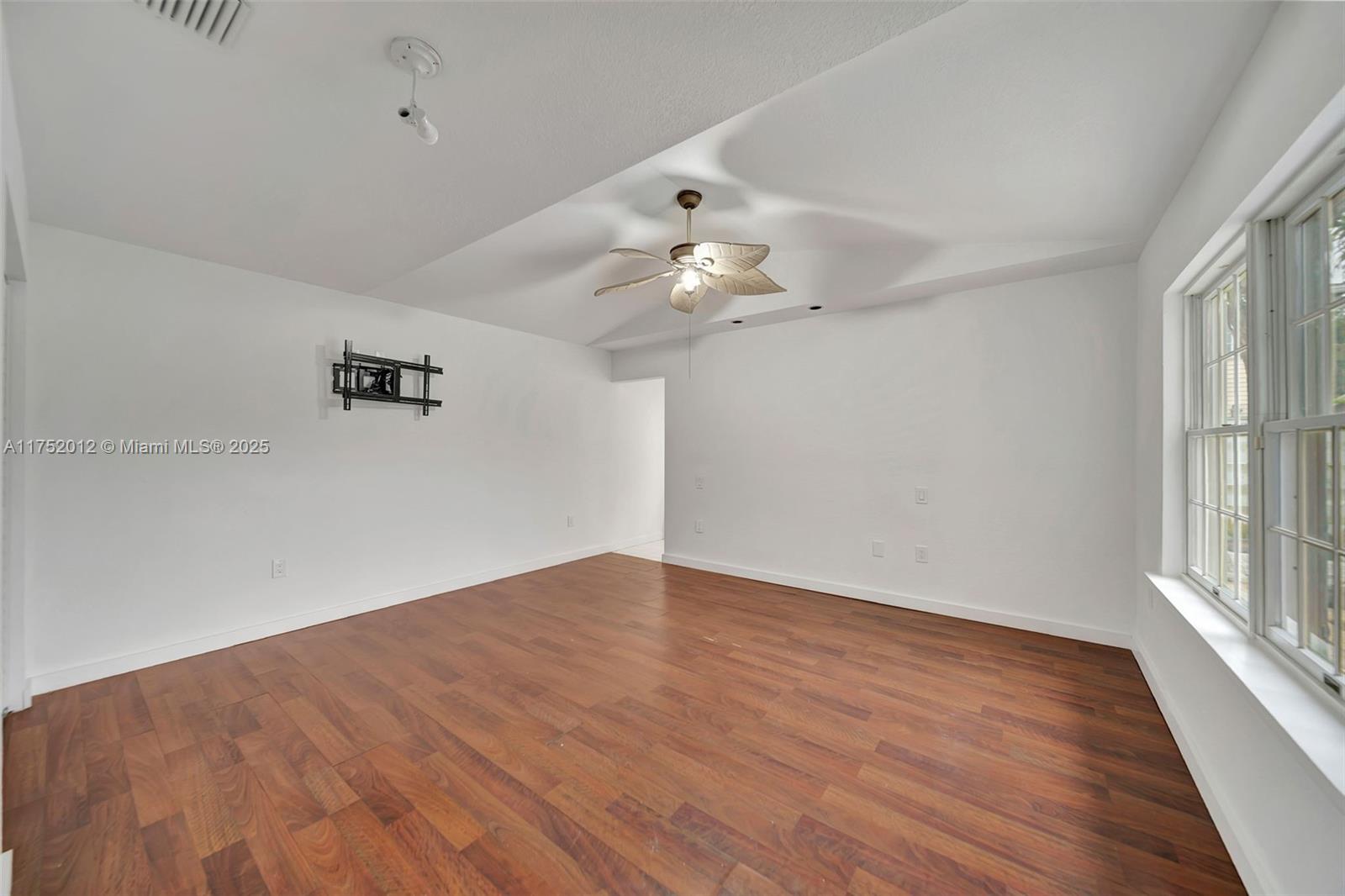 15006 Southwest 141st Court Miami, FL 33186 - Photo 13 of 27 wooden floor in an empty room with a window