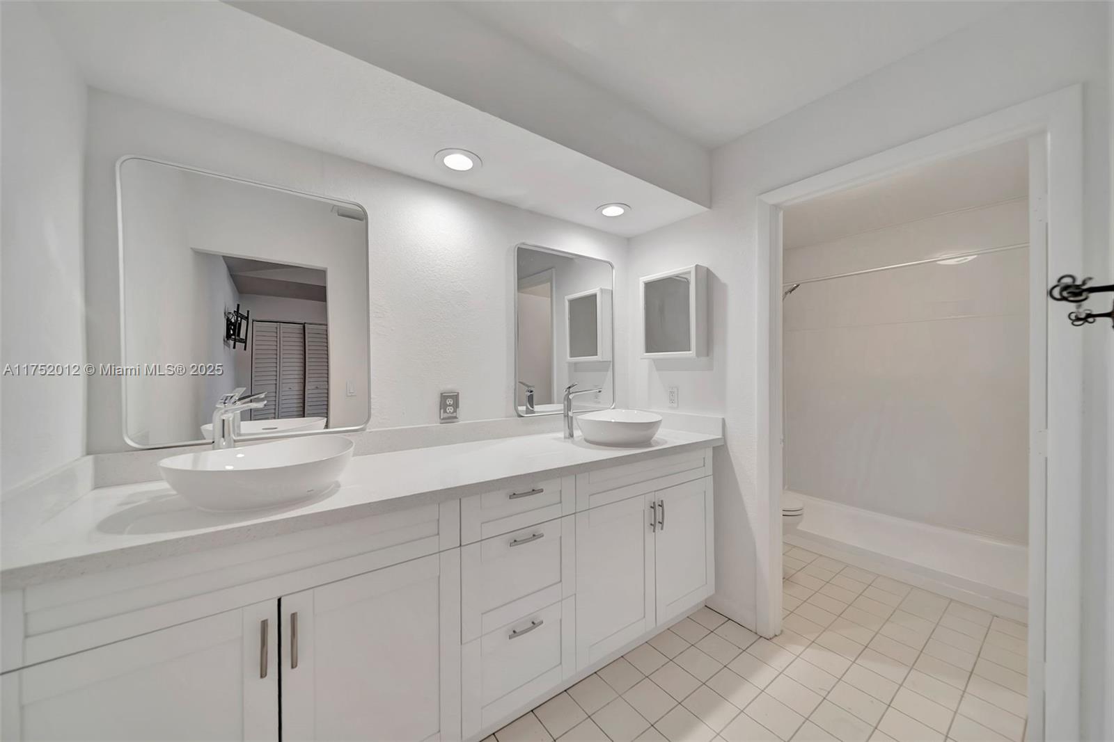 15006 Southwest 141st Court Miami, FL 33186 - Photo 15 of 27 a spacious bathroom with a granite countertop sink mirror and