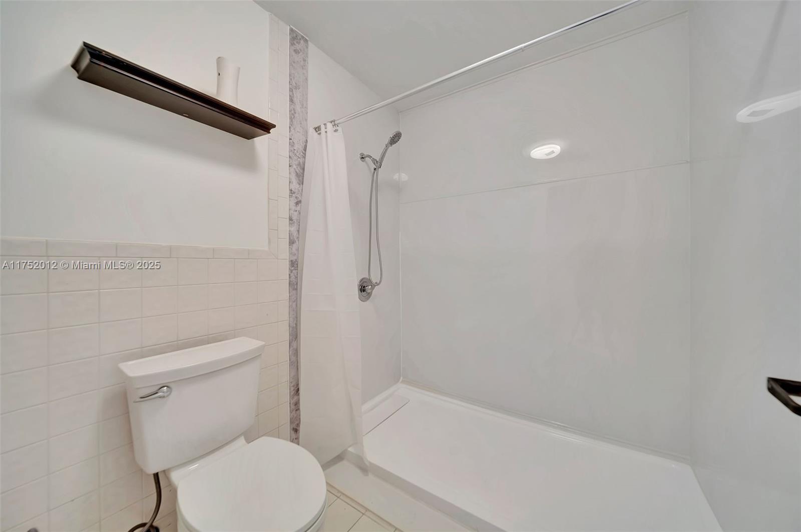 15006 Southwest 141st Court Miami, FL 33186 - Photo 16 of 27 a white toilet sitting next to a bath tub