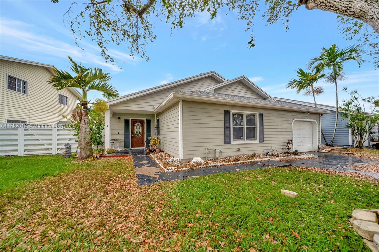 15006 Southwest 141st Court Miami, FL 33186 - Photo 27 of 27 a front view of a house with a garden and patio