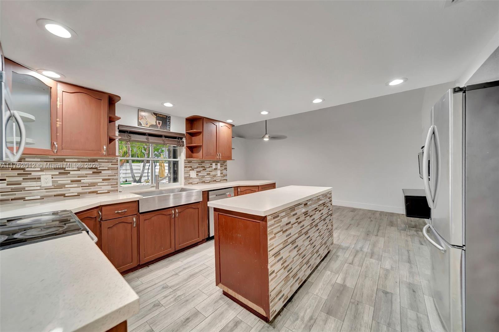 15006 Southwest 141st Court Miami, FL 33186 - Photo 8 of 27 a kitchen with stainless steel appliances granite countertop a stove and a sink