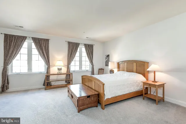 a living room with stainless steel appliances furniture and a flat screen tv