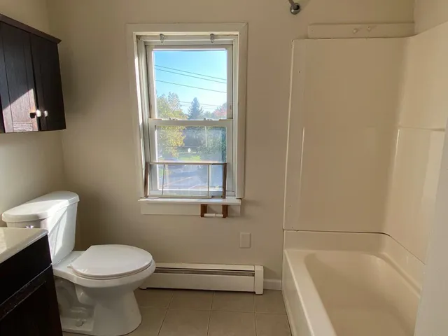 a bathroom with a toilet a sink and bathtub