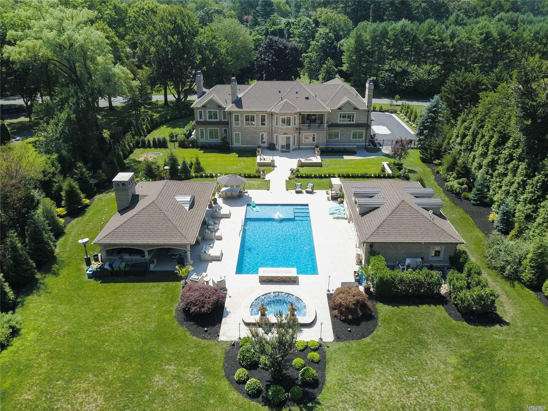 an aerial view of a house with garden space and street view
