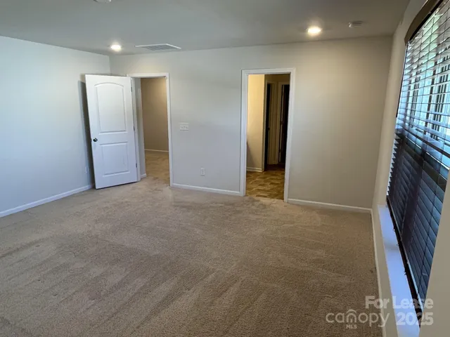 a view of an empty room with a fireplace