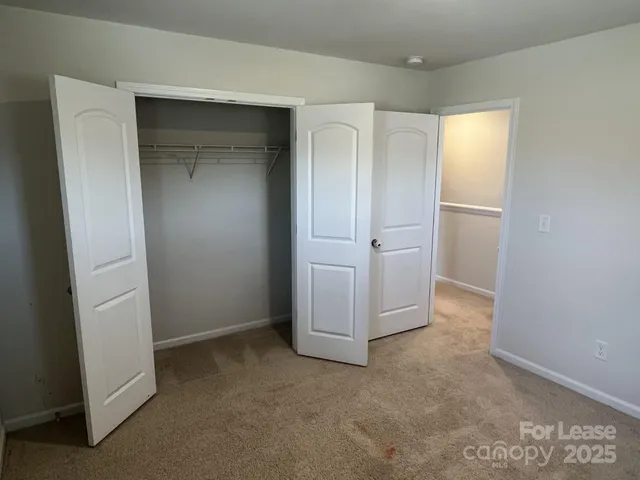 an empty room with closet area