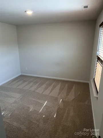 an empty room with a empty space and windows