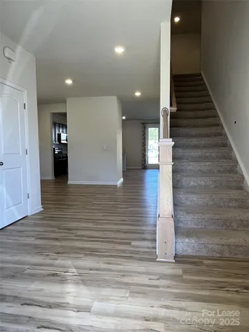 a view of a hallway with stairs and a couch