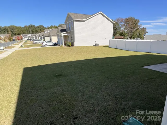 a view of a house with a yard and ocean view