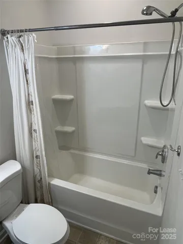 a bathroom with a shower and a toilet